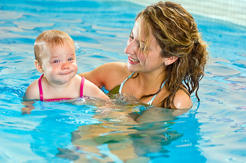 mom and young baby in swimming pool